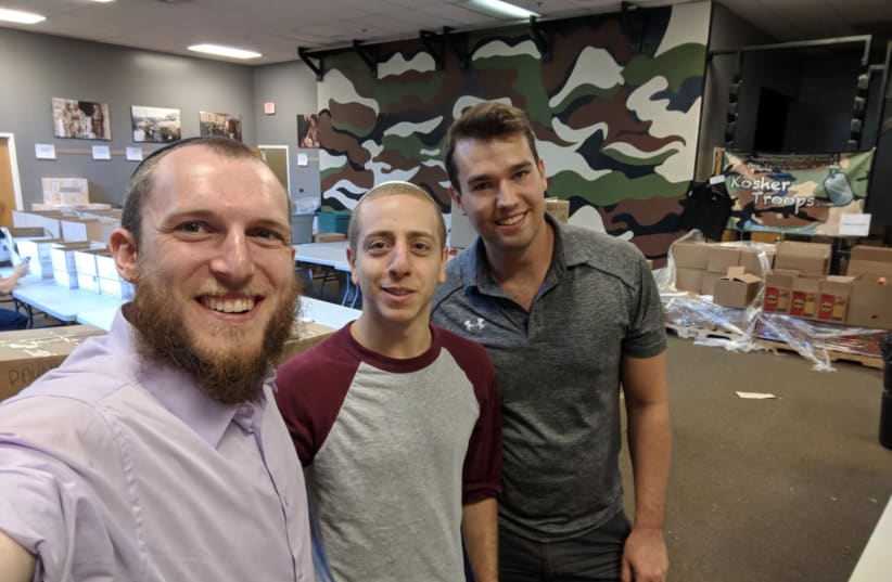 Ari Abramowitz (Left) together with lone soldier veterans Naftoli and Jason packing food for the holidays for US Troops stationed abroad together with KosherTroops.com (photo credit: RABBI ARI ABRAMOWITZ)