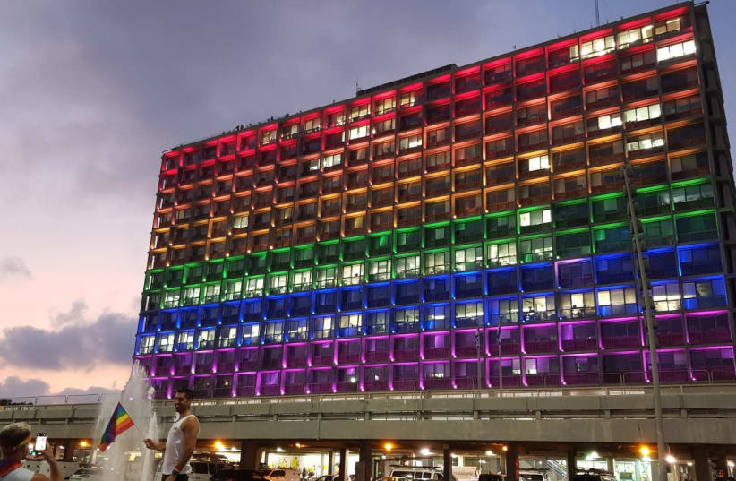 The outside of the Tel Aviv Municipality is lit up to resemble the LGBT Pride flag. (photo credit: COURTESY OF TEL AVIV-YAFO MUNICIPALITY)