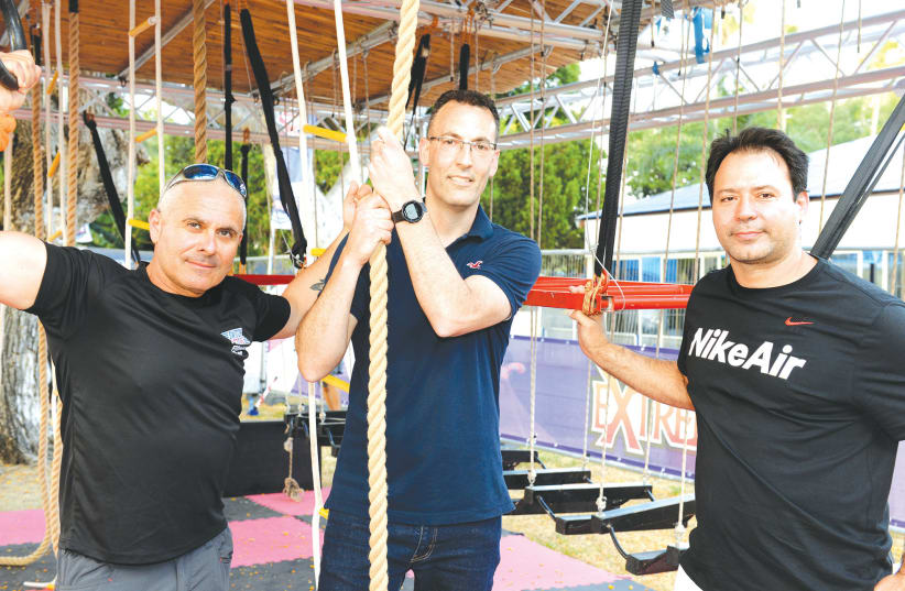 SWITCH ACTIVE OWNER Barak Tzur (left), Dror Morad, CEO of Kfar Maccabiah Hotel, and Olympic bronze-medal judoka Arik Ze’evi try out the new complex. (photo credit: Courtesy)