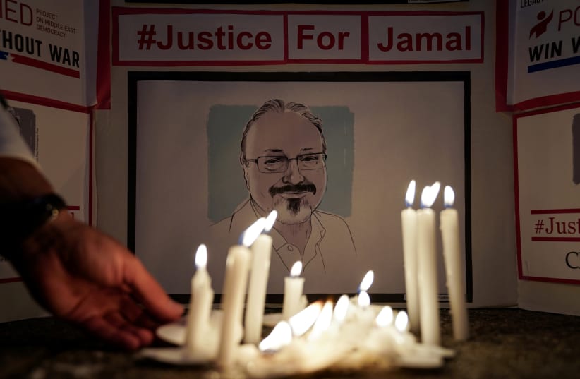 The Committee to Protect Journalists and other press freedom activists hold a candlelight vigil in front of the Saudi Embassy in Washington on October 2, 2019, to mark the anniversary of the killing of journalist Jamal Khashoggi at the kingdom's consulate in Istanbul (photo credit: REUTERS/SARAH SILBIGER)