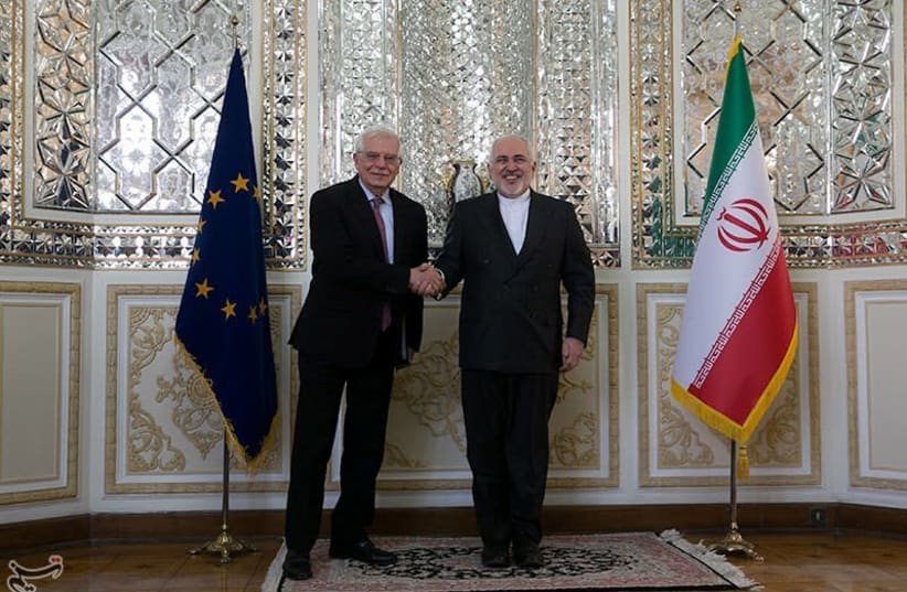 Iranian Foreign Minister Javad Zarif shakes hands with High Representative of the EU for Foreign Affairs and Security Policy and Vice-President of European Commission Josep Borrell in Tehran, Iran, February 3, 2020 (photo credit: TASNIM NEWS AGENCY/HANDOUT VIA REUTERS)