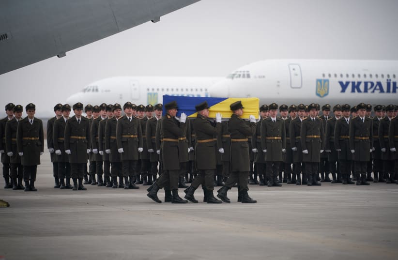 Soldiers carry a coffin containing the remains of one of the eleven Ukrainian victims of the Ukraine International Airlines flight 752 plane disaster during a memorial ceremony at the Boryspil International Airport, outside Kiev, Ukraine January 19, 2020. (photo credit: REUTERS)