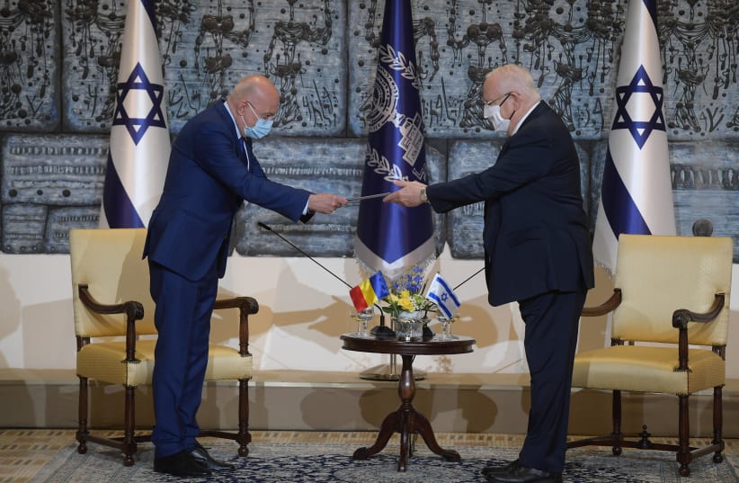 President Reuven Rivlin is seen accepting the credentials of Romanian Ambassador to Israel Radu Ioanid. (photo credit: AMOS BEN-GERSHOM/GPO)