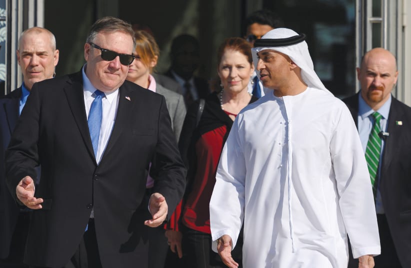 US SECRETARY of State Mike Pompeo speaks with the Emirati Ambassador to the US Yousef Al Otaiba in Abu Dhabi, UAE, in January 2019. (photo credit: ANDREW CABALLERO-REYNOLDS/REUTERS)