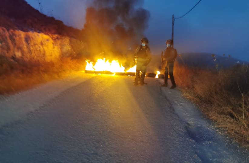 Border Police officers attempt to remove Israeli settlers from constructing an illegal structure, Yitzhar, West Bank, July 10, 2020 (photo credit: BORDER POLICE SPOKESPERSON)