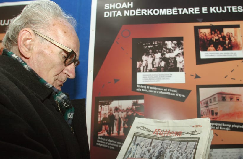 Beqir Xhepa, 80, an Albanian who was caught as a partisan courier by the Germans during World War Two and sent to the concentration camps at Mathausen and Auschwitz, points at himself in a picture taken when he was a prisoner, in Tirana, January 27, 2005 (photo credit: REUTERS)