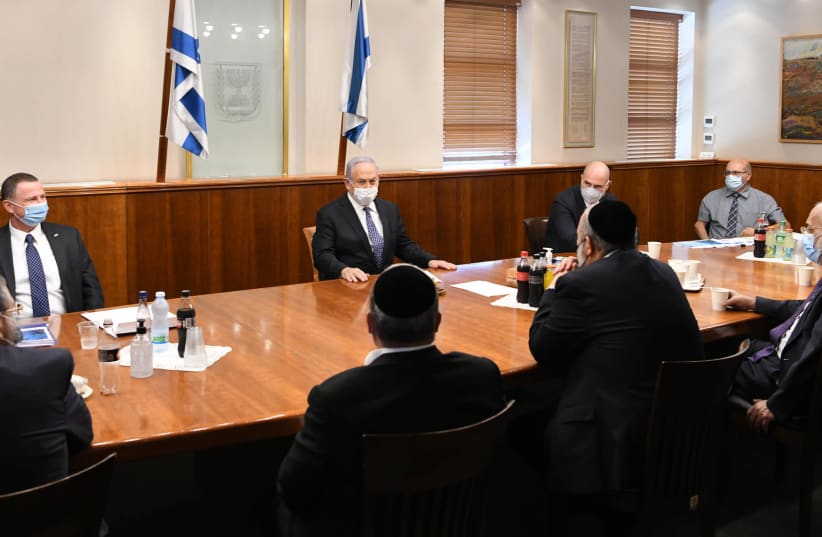 Prime Minister Benjamin Netanyahu meets with ministers to discuss the proposed restrictions on ultra-Orthodox neighborhoods, July 13, 2020  (photo credit: AMOS BEN-GERSHOM/GPO)