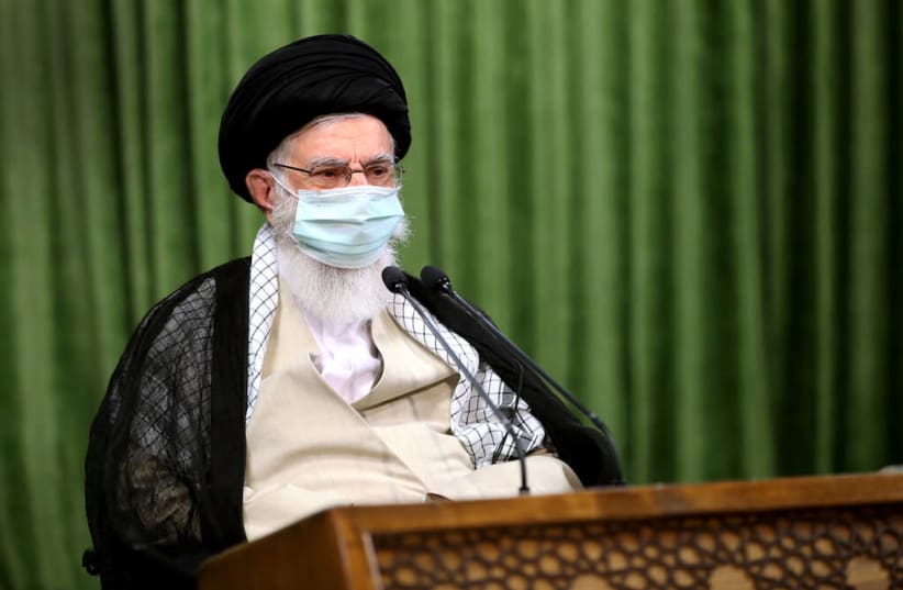 Iran's Supreme Leader Ayatollah Ali Khamenei wears a protective face mask, during a virtual meeting with lawmakers in Tehran (photo credit: REUTERS)