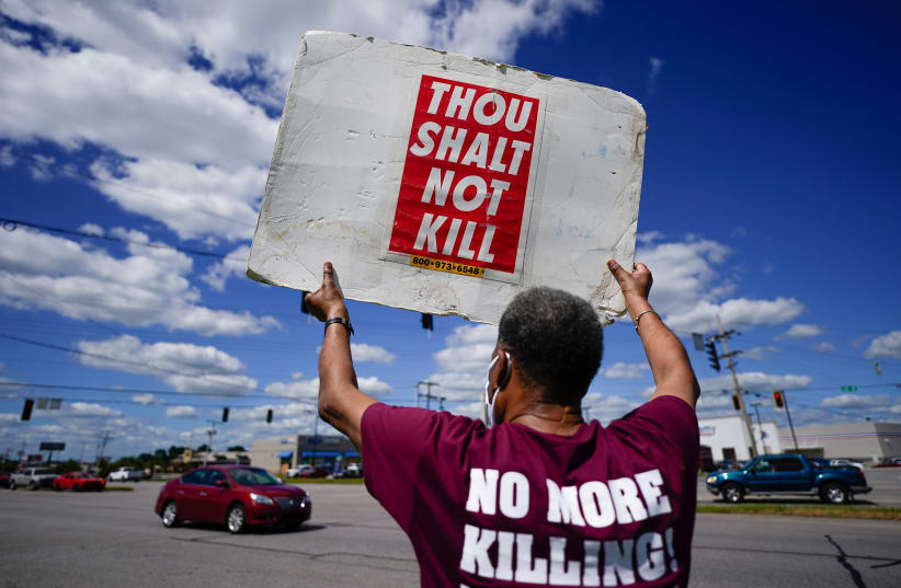 Reverend Sylvester Edwards, President of the Terre Haute NAACP, stands near the Federal Correctional Institution, Terre Haute, to express his opposition to the death penalty and execution of Daniel Lewis Lee. July 13, 2020 (photo credit: BRYAN WOOLSTON/REUTERS)