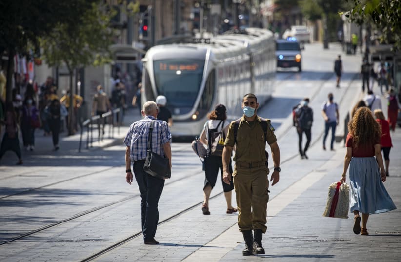 Jerusalemites wearing face masks for fear of coronavirus  walk on Jaffa road in the City Center of Jerusalem on July 12, 2020. Israel has seen a spike of new COVID-19 cases,  cabinet ministers imposed new restrictions on public gatherings in a bid to stem the rising infection rate of the coronavirus (photo credit: OLIVIER FITOUSSI/FLASH90)
