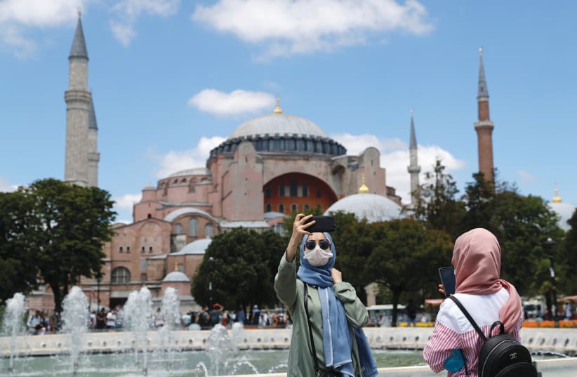 POSING FOR a selfie in front of Hagia Sophia in Istanbul, Turkey, on July 11 (photo credit: MURAD SEZER/REUTERS)