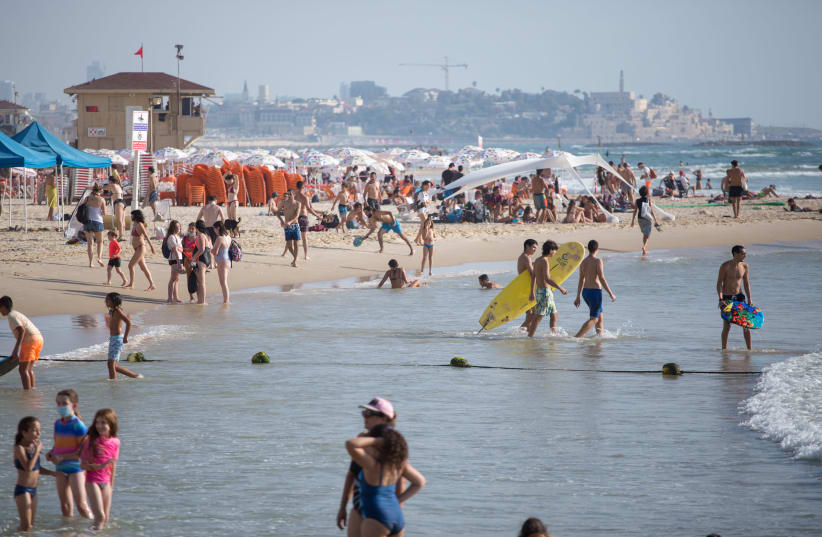 Israelis enjoy the beach in Tel Aviv, July 15, 2020 (photo credit: MIRIAM ALSTER/FLASH90)