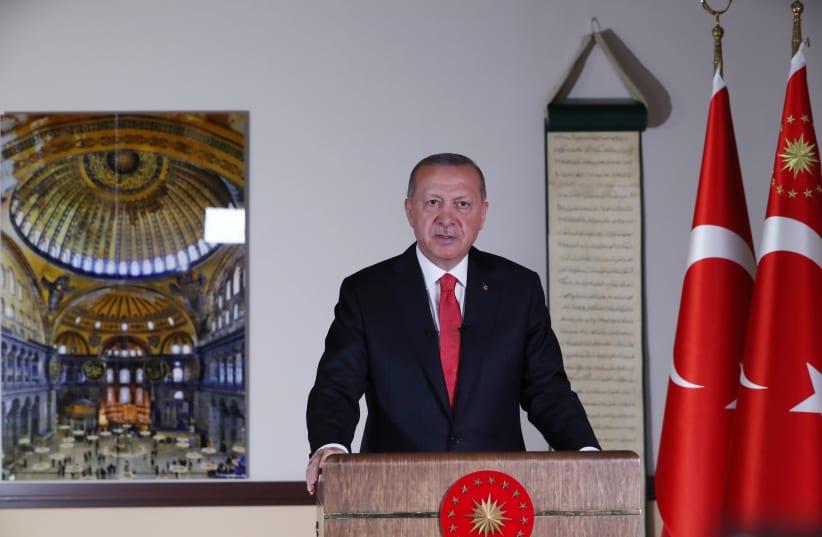 Turkish President Tayyip Erdogan, with a picture of Hagia Sophia or Ayasofya in the background, delivers a televised address to the nation in Ankara, Turkey, July 10, 2020 (photo credit: TURKISH PRESIDENTIAL PRESS OFFICE/VIA REUTERS)