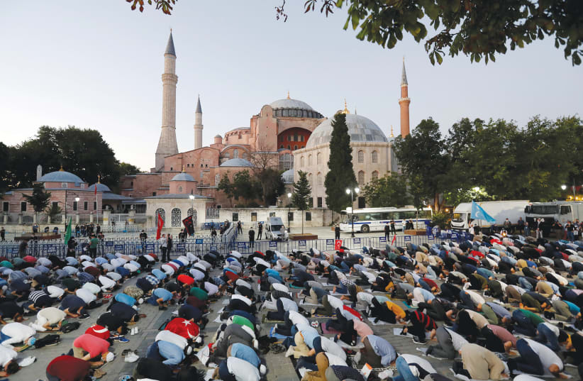 MUSLIMS PRAY in front of the Hagia Sophia in Istanbul earlier this month. (photo credit: MURAD SEZER/REUTERS)