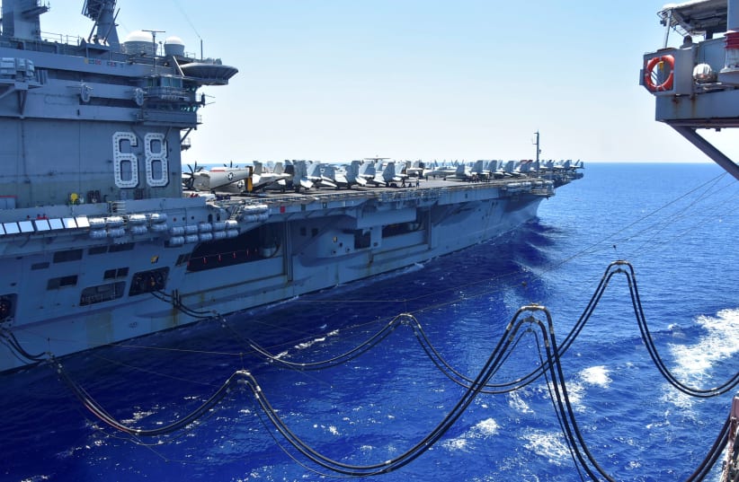 The U.S. Navy aircraft carrier USS Nimitz receives fuel from the Henry J. Kaiser-class fleet replenishment oiler USNS Tippecanoe during an underway replenishment in the South China Sea July 7, 2020. (photo credit: REUTERS)