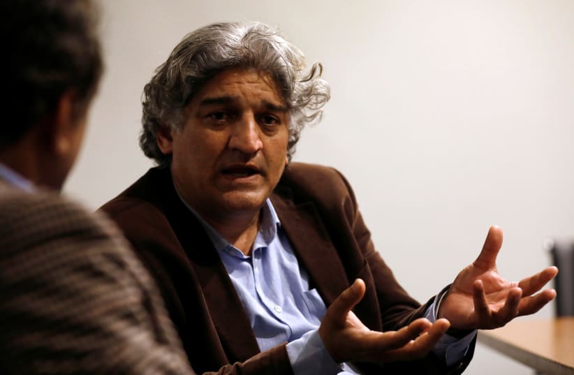 Matiullah Jan, a journalist and columnist, gestures during an interview with Reuters at his office in Islamabad, Pakistan March 13, 2019. (photo credit: REUTERS/AKHTAR SOOMRO)