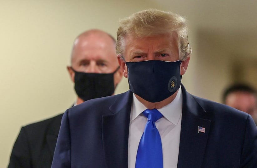 FILE PHOTO: U.S. President Donald Trump wears a mask while visiting Walter Reed National Military Medical Center in Bethesda, Maryland, U.S., July 11, 2020. REUTERS/Tasos Katopodis  (photo credit: TASOS KATOPODIS/ REUTERS)