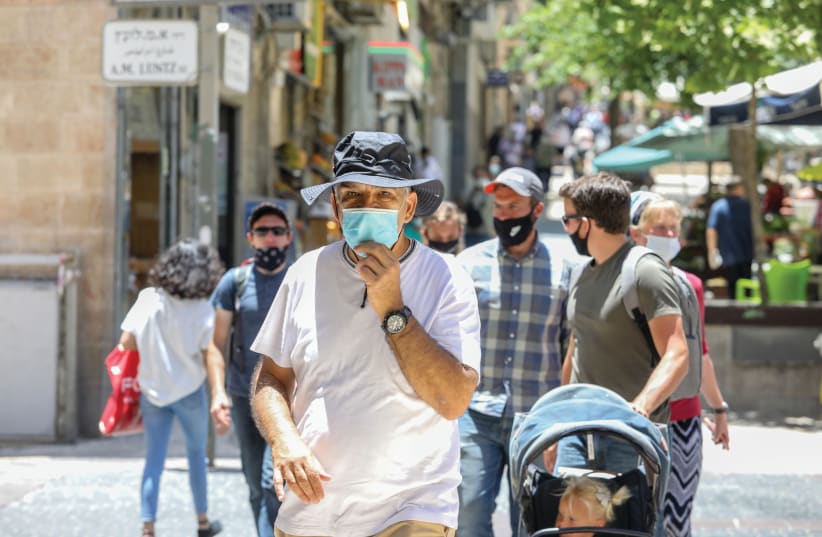 An illustrative photo of men wearing masks in Jerusalem (photo credit: MARC ISRAEL SELLEM)