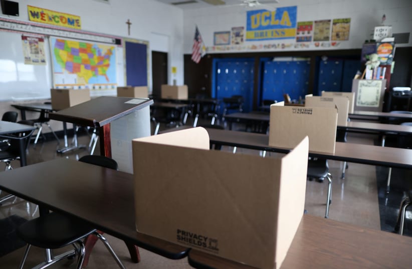Social distancing dividers for students are seen in a classroom at St. Benedict School, amid the outbreak of the coronavirus disease (COVID-19), in Montebello, near Los Angeles (photo credit: REUTERS)