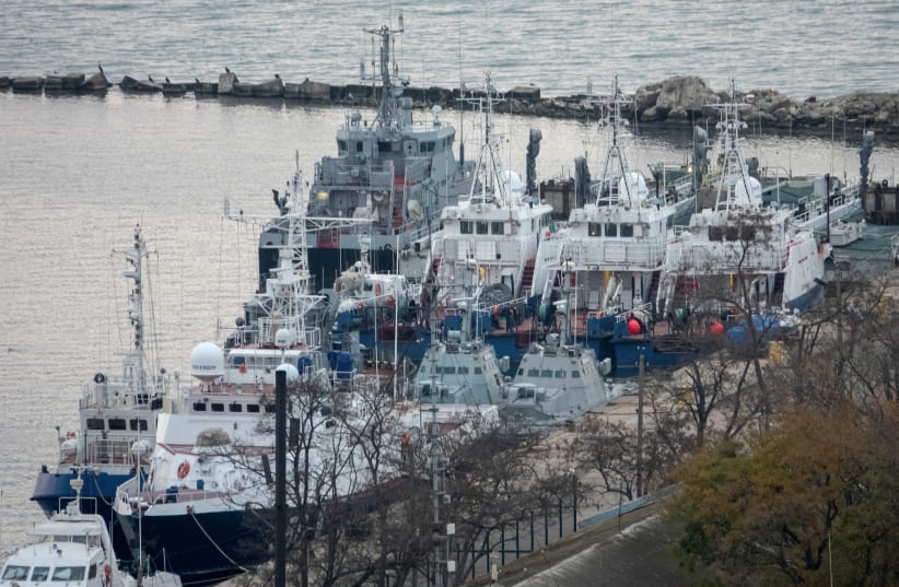 SEIZED UKRAINIAN naval ships are guarded by Russian Coast Guard vessels in the port in Kerch, near the bridge connecting the Russian mainland with the Crimean Peninsula, in November 2019 (photo credit: ALLA DMITRIEVA/REUTERS)
