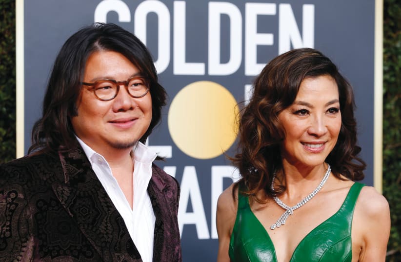 AUTHOR KEVIN KWAN and ‘Crazy Rich Asians’ star Michelle Yeoh are all smiles at the 76th Golden Globe Awards in Beverly Hills last year (photo credit: MIKE BLAKE/REUTERS)