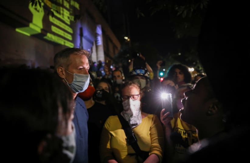 Portland's Mayor Ted Wheeler listens to a member of the public during a demonstration against the presence of federal law enforcement officers and racial inequality in Portland, Oregon, US, July 22, 2020. (photo credit: CAITLIN OCHS/REUTERS)