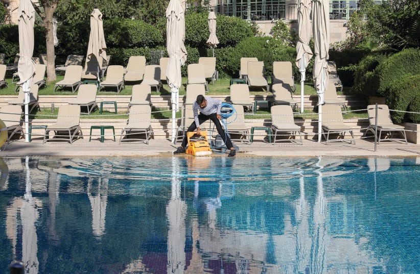 LEANING THE empty King David Hotel pool in Jerusalem and waiting for tourists.  (photo credit: MARC ISRAEL SELLEM)