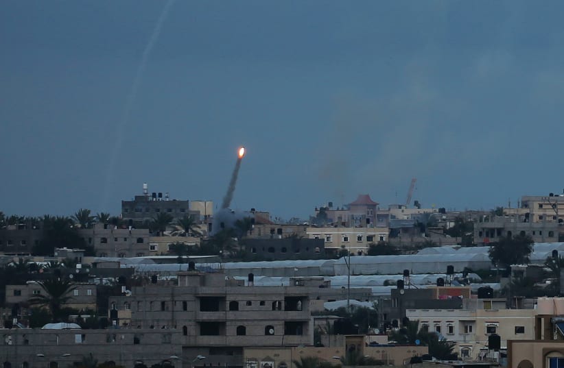 A ROCKET IS fired toward Israel from the southern Gaza Strip in February. (photo credit: IBRAHEEM ABU MUSTAFA / REUTERS)