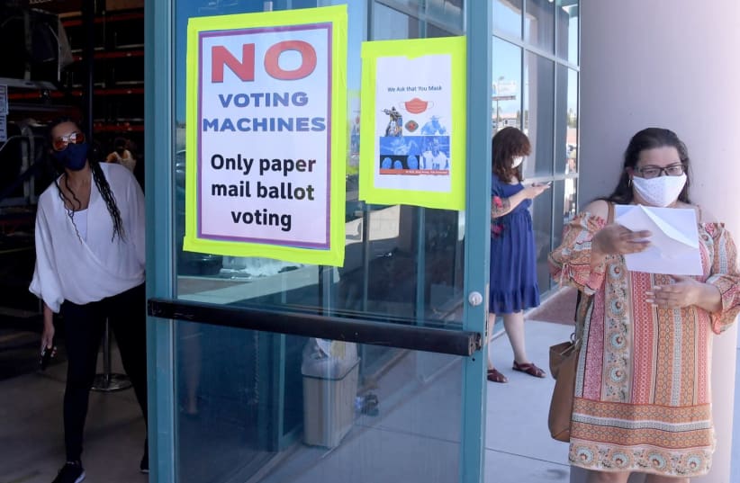 Prospective voters wait in line outside the Clark County Election Department in North Las Vegas, Nev., June 9, 2020. (photo credit: ETHAN MILLER / GETTY IMAGES NORTH AMERICA / AFP)
