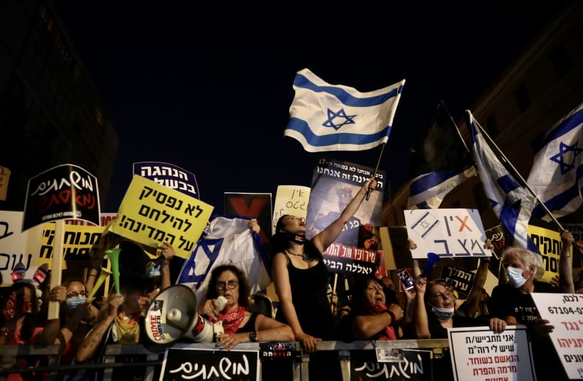 Protesters gather out the Prime Minister's Residence to protest Prime Minister Benjamin Netanyahu's COVID-19 response and the ongoing financial difficulties it has caused, July 23, 2020 (photo credit: MARC ISRAEL SELLEM/THE JERUSALEM POST)
