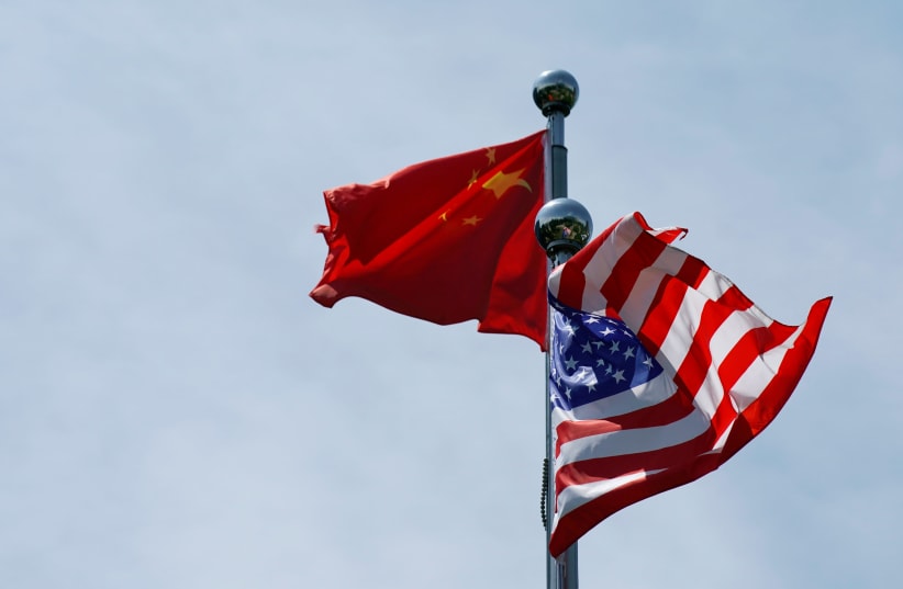 Chinese and US flags flutter before a trade meeting in Shanghai, China July 30, 2019 (photo credit: REUTERS/ALY SONG)