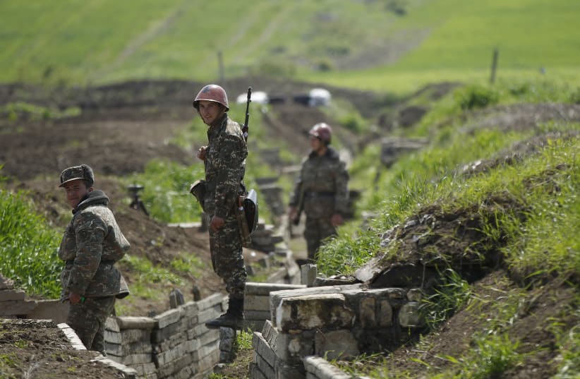Ethnic Armenian soldiers stand in a trench at their position near Nagorno-Karabakh's town of Martuni, April 8, 2016.  (photo credit: REUTERS)