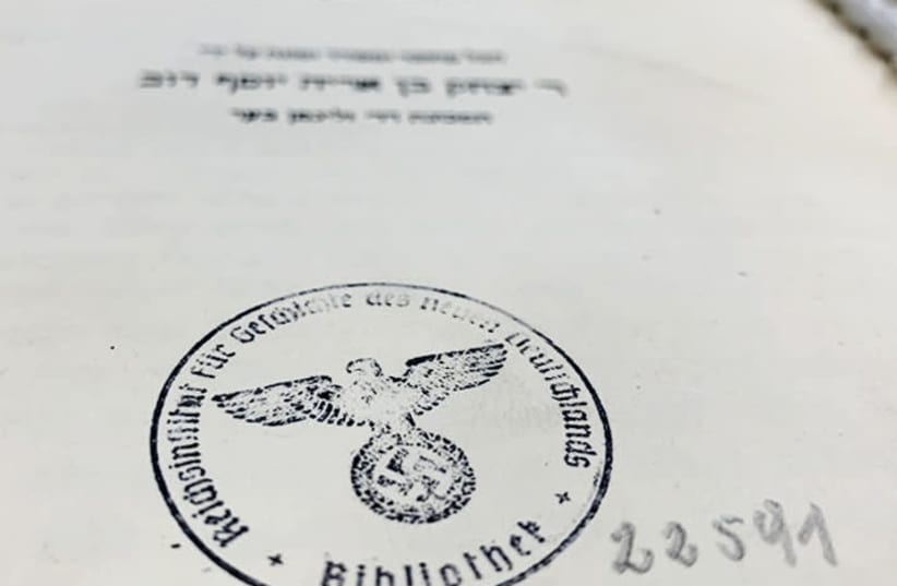 A stamp featuring a Nazi "Imperial Eagle" clutching a swastika - the "Reichsadler", found on the siddur's title page (photo credit: UDI EDERY)