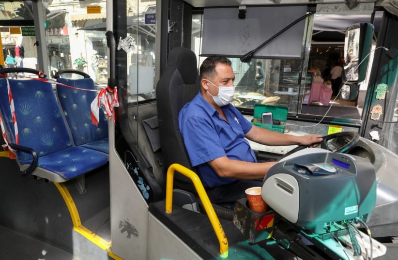 Bus driver works during the coronavirus outbreak, 2020 (photo credit: MARC ISRAEL SELLEM)