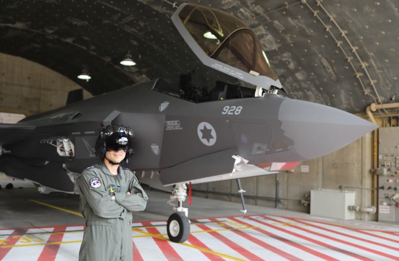 AN IAF pilot poses proudly next to an F-35 (photo credit: MARC ISRAEL SELLEM/THE JERUSALEM POST)