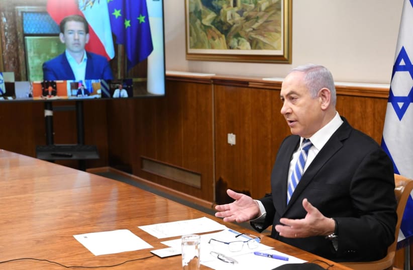 Prime Minister Benjamin Netanyahu consults on coronavirus with world leaders on July 29, 2020 (photo credit: AMOS BEN GERSHOM, GPO)