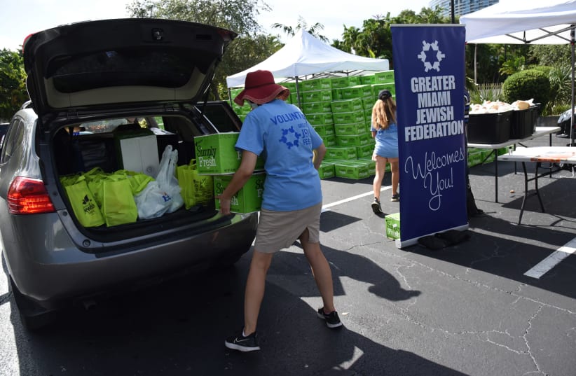  July 29, 2020, Miami, FL Volunteers distribute food at a kosher drive-thru site set up at the Greater Miami Jewish Federation. (photo credit: MICHELE EVE PHOTOGRAPHY)