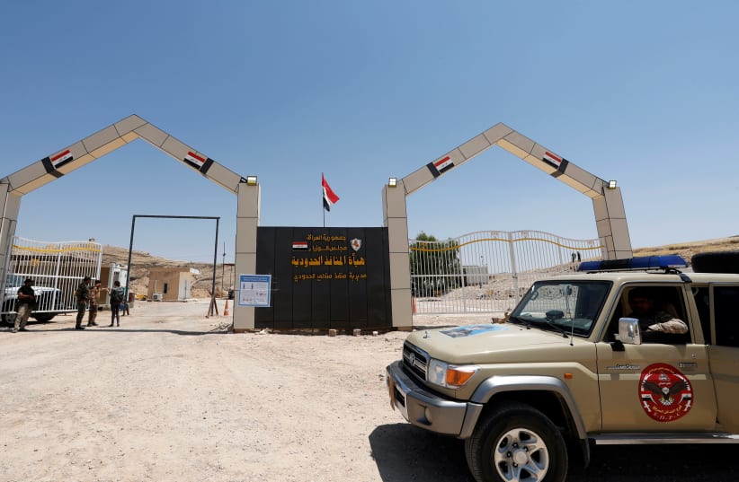 A military vehicle of members of the Popular Mobilization Forces (PMF) and Iraqi Border Guards are seen on the Iraqi side of Mandali border crossing between Iraq and Iran, in Mandali, Iraq July 11, 2020.  (photo credit: REUTERS)