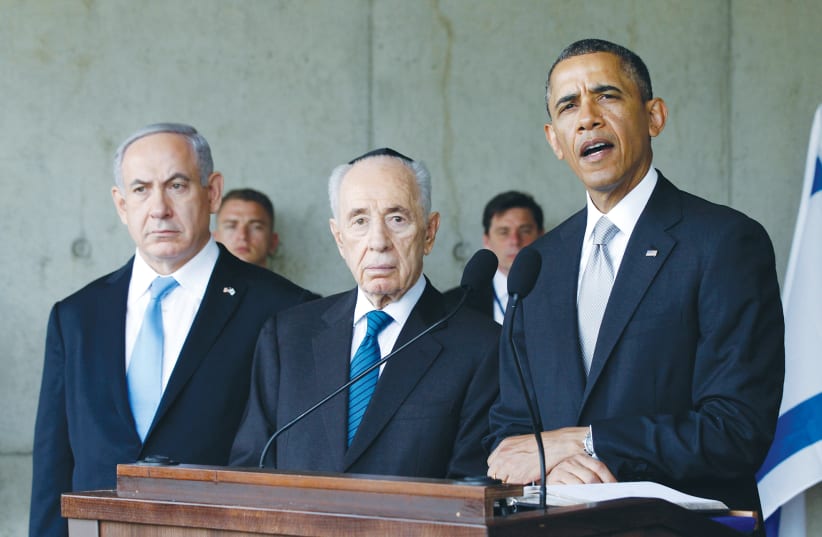 THEN-US president Barack Obama speaks alongside Prime Minister Benjamin Netanyahu and president Shimon Peres during his visit to Yad Vashem in 2013. (photo credit: JASON REED/REUTERS)
