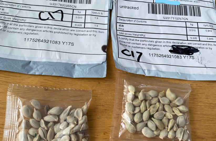 Packages of unidentified seeds which appear to have been mailed from China to U.S. postal addresses are seen at the Washington State Department of Agriculture (WSDA) in Olympia, Washington July 24, 2020. (photo credit: REUTERS)