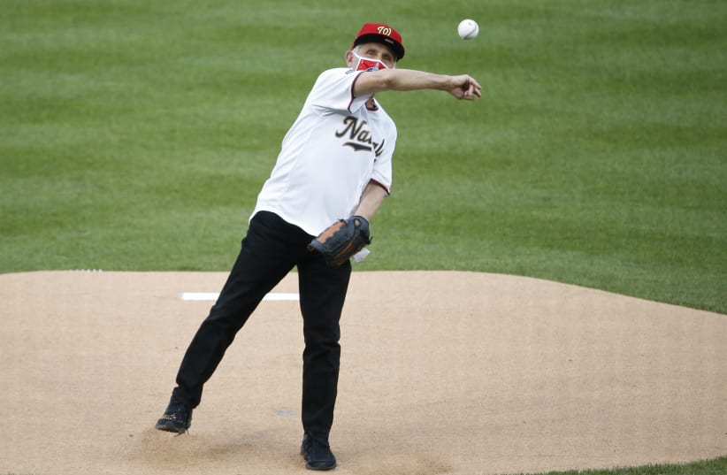 Jul 23, 2020; Washington, DC, USA; National Institute of Allergy and Infectious Diseases director Dr. Anthony Fauci throws out the ceremonial first pitch before MLB Opening Day between the New York Yankees and the Washington Nationals at Nationals  (photo credit: GEOFF BURKE-USA TODAY SPORTS/VIA REUTERS)