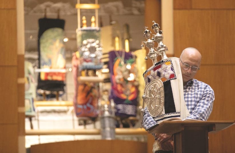 A LIVESTREAM SERVICE from inside Temple Shir Shalom in West Bloomfield Township, Michigan, March 2020. (photo credit: EMILY ELCONIN/REUTERS)