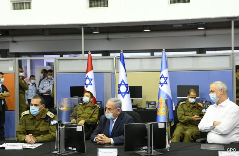 Prime Minister Benjamin Netanyahu pictured next to Alternate Prime Minister Benny Gantz, among senior IDF officials, August 4, 2020 (photo credit: AMOS BEN GERSHOM, GPO)