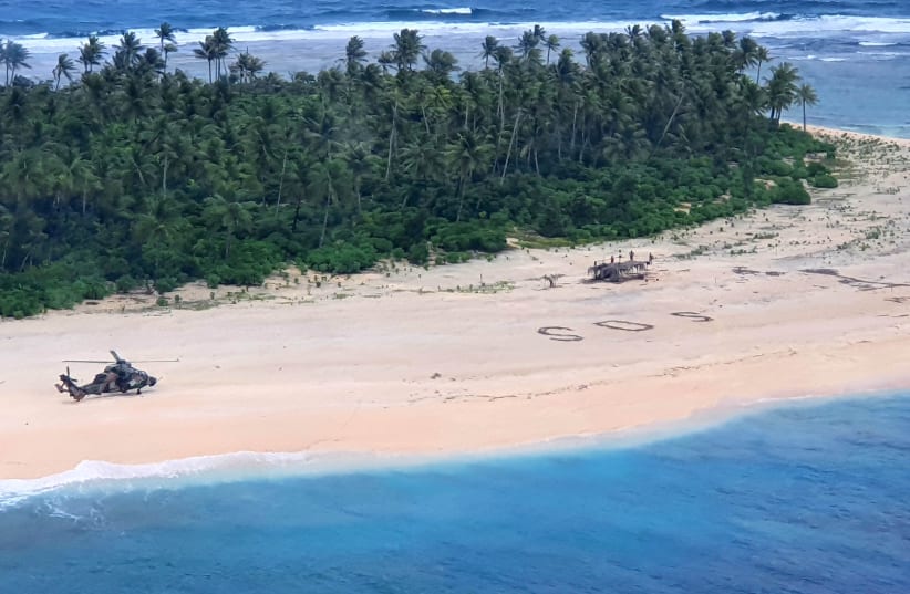 An Australian Army ARH-90 Tiger Helicopter lands on Pikelot Island in the Federated States of Micronesia where three men were found safe and healthy after missing for three days, August 2, 2020. Picture taken August 2, 2020. (photo credit: AUSTRALIAN DEPARTMENT OF DEFENCE/REUTERS)