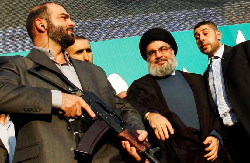 Lebanon's Hezbollah leader Sayyed Hassan Nasrallah, escorted by his bodyguards, greets his supporters at an anti-US protest in Beirut's southern suburbs, Lebanon September 17, 2012 (photo credit: REUTERS/SHARIF KARIM/FILE PHOTO)