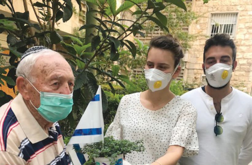 BNEI AKIVA members present David Scharf with a plant, honoring him on Yom Haatzmaut. (photo credit: Courtesy)