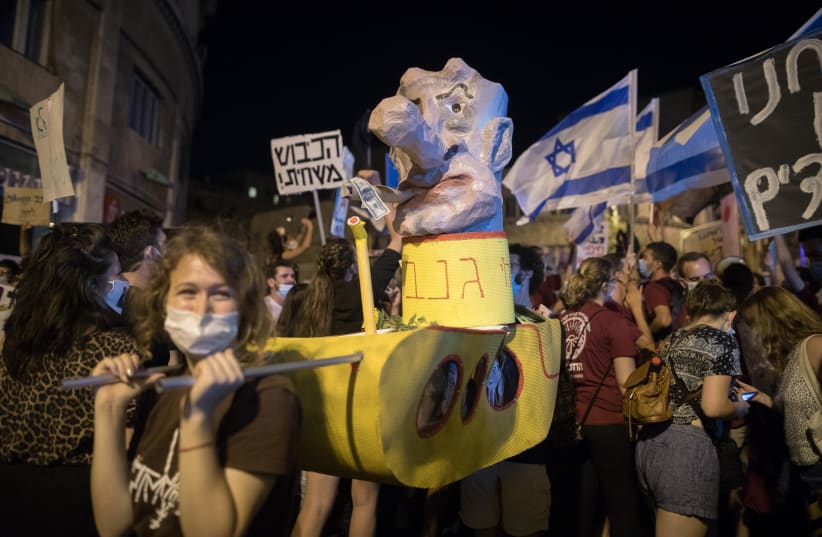 CARRYING AN effigy of Prime Minister Benjamin Netanyahu, labeling him a ‘ganav’ (thief), at the demonstration outside his Jerusalem residence on August 1. (photo credit: NOAM REVKIN FENTON/FLASH90)