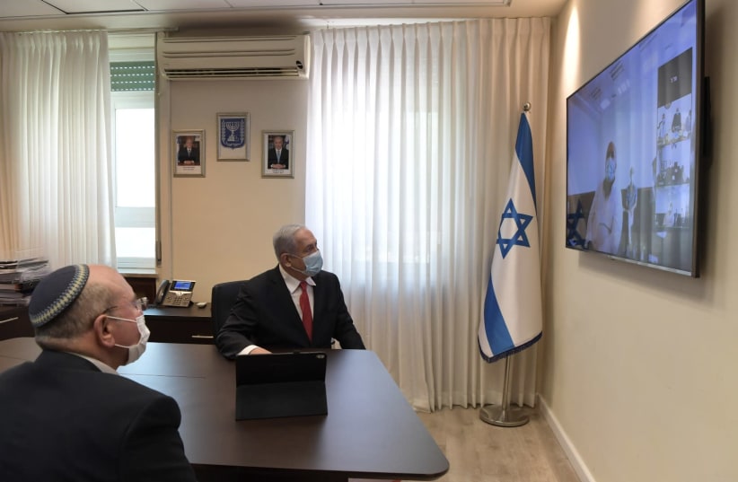 Prime Minister Benjamin Netanyahu holds a video call with IIBR members following the institute's progress toward launching a vaccine for the coronavirus. (photo credit: KOBI GIDEON/GPO)