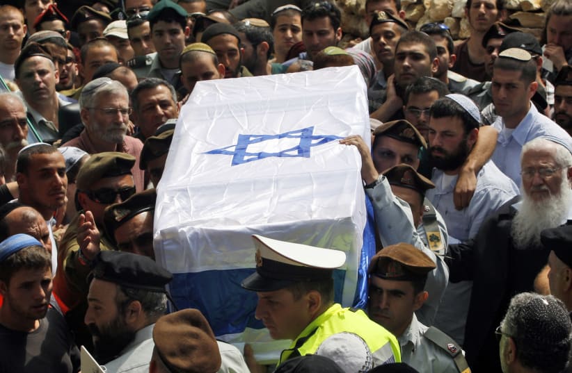 sraeli soldiers carry the flag-draped coffin of their comrade Eliraz Peretz during his funeral at Mount Herzl military cemetery in Jerusalem March 28, 2010 (photo credit: REUTERS/BAZ RATNER)