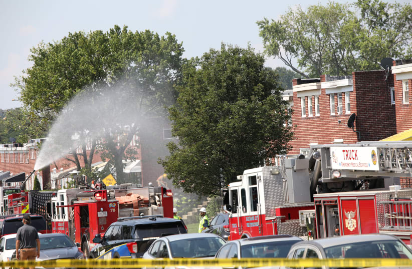 Fire trucks are seen at the scene of an explosion in a residential area of Baltimore Fire trucks are seen at the scene of an explosion in a residential area of Baltimore, Maryland, U.S. August 10, 2020. (photo credit: REUTERS/ROSEM MORTON)